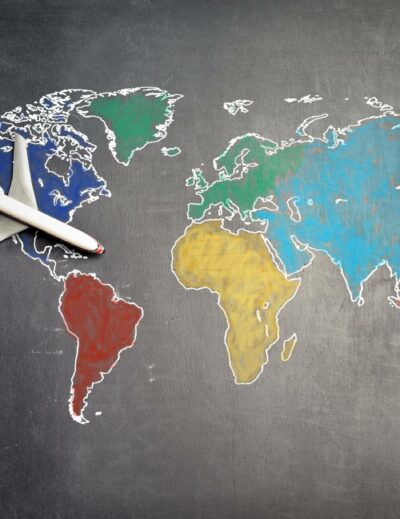 person with toy airplane on world map